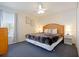 Cozy bedroom with a large bed, a ceiling fan, a chest of drawers, and a view to the yard at 7902 Silver Bass Ct, Kissimmee, FL 34747
