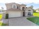 Charming two-story home with an attached garage and a beautifully paved driveway, blending curb appeal and practicality at 7902 Silver Bass Ct, Kissimmee, FL 34747