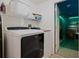 Laundry room with a washer, dryer, shelving and access to a game room at 7902 Silver Bass Ct, Kissimmee, FL 34747