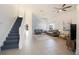 Bright living room has soaring ceilings, tile floors, and a staircase to the second floor at 7902 Silver Bass Ct, Kissimmee, FL 34747