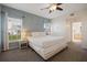 This beautiful main bedroom is light and airy with large windows and a ceiling fan at 7902 Silver Bass Ct, Kissimmee, FL 34747