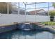 A pristine pool featuring a waterfall, tile accents, and a screened enclosure, for sunny, refreshing swims at 7902 Silver Bass Ct, Kissimmee, FL 34747