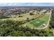 Aerial view showcasing a community with a golf course, soccer field, and mature trees at 819 Veranda Pl, Celebration, FL 34747