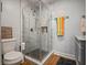 Bathroom featuring a glass shower with marble tiles, black hexagon floor tiles, and a vanity with a marble countertop at 819 Veranda Pl, Celebration, FL 34747