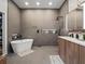 Sleek bathroom with a modern soaking tub, walk-in shower, and floating vanity at 819 Veranda Pl, Celebration, FL 34747