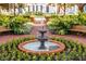 Charming courtyard with a central fountain, manicured landscaping, benches and surrounding brick walkways at 819 Veranda Pl, Celebration, FL 34747