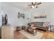 Cozy living room featuring a comfortable couch, stylish decor, a ceiling fan, and hardwood floors at 819 Veranda Pl, Celebration, FL 34747