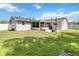 Large backyard with screened in porch, fence, fire pit, and shed at 8508 Alveron Ave # 1, Orlando, FL 32817