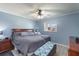 Comfortable bedroom with a ceiling fan, a queen-sized bed, and a window overlooking the neighborhood at 8508 Alveron Ave # 1, Orlando, FL 32817