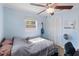 Cozy bedroom features a ceiling fan, window, and closet, plus personal touches at 8508 Alveron Ave # 1, Orlando, FL 32817