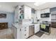 Updated kitchen featuring white cabinets, a subway tile backsplash, and stainless steel appliances at 8508 Alveron Ave # 1, Orlando, FL 32817