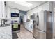 Well-lit kitchen with stainless steel appliances, white cabinets, and modern countertops at 8508 Alveron Ave # 1, Orlando, FL 32817
