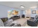 Inviting living room with large windows and a modern entertainment center at 8508 Alveron Ave # 1, Orlando, FL 32817