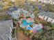 Aerial view of community pool featuring palm trees and patio furniture at 8929 Legacy Ct # 106, Kissimmee, FL 34747