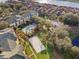 Aerial view of a community with a pool, volleyball court, playground, and residences near a lake at 8929 Legacy Ct # 106, Kissimmee, FL 34747