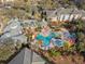 Community aerial view showcasing pool with lounge chairs, landscaping, and nearby residences at 8929 Legacy Ct # 106, Kissimmee, FL 34747
