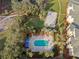Aerial shot of a community featuring a pool, volleyball court, and lush landscaping at 8929 Legacy Ct # 106, Kissimmee, FL 34747