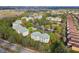 Aerial view of community with multiple buildings, green space, and a pond at 8929 Legacy Ct # 106, Kissimmee, FL 34747