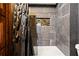 Bathroom showing tiled walls, a built in shelf in the shower and a dark shower curtain at 8929 Legacy Ct # 106, Kissimmee, FL 34747