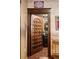 Seen through an ornate door frame is a bathroom with black vanity and walls, with an open door at 8929 Legacy Ct # 106, Kissimmee, FL 34747