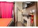 Bedroom features a stone fireplace with mounted television and pink curtains around the bed at 8929 Legacy Ct # 106, Kissimmee, FL 34747