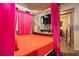 This bedroom has a stone fireplace with a mounted television, four poster bed with drapes, and entry to bathroom at 8929 Legacy Ct # 106, Kissimmee, FL 34747