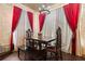 Another view of the dining area featuring dark wood floors, brick walls, and elegant decor at 8929 Legacy Ct # 106, Kissimmee, FL 34747