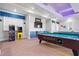 Fun game room with arcade games, pool tables, a TV, and vibrant, playful decor at 8929 Legacy Ct # 106, Kissimmee, FL 34747