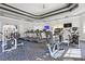 Well-equipped gym featuring modern treadmills, stationary bikes, weight machines, and sleek, neutral decor at 8929 Legacy Ct # 106, Kissimmee, FL 34747