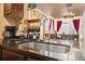 This unique kitchen has brick detailing, a gooseneck faucet, granite countertops, with view into the dining area at 8929 Legacy Ct # 106, Kissimmee, FL 34747