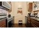 Kitchen featuring stainless appliances and decorative copper pots hanging above the sink at 8929 Legacy Ct # 106, Kissimmee, FL 34747