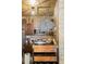 Quirky kitchen with brick backsplash, stainless appliances and a custom witch design element hanging in the space at 8929 Legacy Ct # 106, Kissimmee, FL 34747