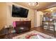 Living Room featuring large screen television, display table, and adjoining kitchen at 8929 Legacy Ct # 106, Kissimmee, FL 34747