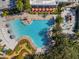 An aerial view of the pool and recreation area with a mini-golf course and pirate-themed water playground at 925 Conch Rd, Davenport, FL 33896