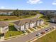 New townhome community featuring attached garages, front lawns, and scenic surroundings at 925 Conch Rd, Davenport, FL 33896