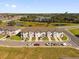 Overhead of townhomes with driveways, landscaping, nearby pond, and scenic views at 925 Conch Rd, Davenport, FL 33896