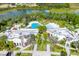 Stunning aerial view of a community showcasing a large pool, lush landscaping, and various amenities at 925 Conch Rd, Davenport, FL 33896