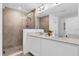 Bathroom featuring a tiled walk-in shower and double vanity at 925 Conch Rd, Davenport, FL 33896