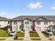 Charming townhome exterior featuring attached garages, neutral paint, and manicured landscaping at 925 Conch Rd, Davenport, FL 33896