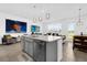 Open concept kitchen and living room area with a large center island and modern pendant lighting at 925 Conch Rd, Davenport, FL 33896