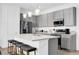 Contemporary kitchen boasts a large center island with bar stools, sleek counter tops and cabinets at 925 Conch Rd, Davenport, FL 33896