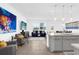 Open concept living and kitchen area featuring modern gray kitchen, and stylish furniture at 925 Conch Rd, Davenport, FL 33896