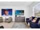 Comfortable living room features stylish furniture, decor, and a large TV for entertainment at 925 Conch Rd, Davenport, FL 33896
