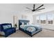 Inviting bedroom with a plush blue bed, sitting area, and large windows for natural light at 925 Conch Rd, Davenport, FL 33896