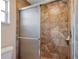 Shower with textured walls and glass doors at 103 N Atlas Dr, Apopka, FL 32703