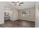 Spacious bedroom featuring neutral walls, new floors, ceiling fan, and attached vanity at 103 N Atlas Dr, Apopka, FL 32703