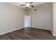 Clean bedroom featuring neutral walls, new floors, ceiling fan, and a closet at 103 N Atlas Dr, Apopka, FL 32703