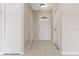 Bright foyer with neutral-colored walls, tiled flooring, a decorative front door, and closet storage at 103 N Atlas Dr, Apopka, FL 32703