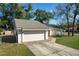 Lovely single-story home featuring a stone facade, garage, and a well-maintained lawn at 103 N Atlas Dr, Apopka, FL 32703