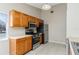 Kitchen featuring tile floors, cabinets, range, microwave, and stainless steel refrigerator at 103 N Atlas Dr, Apopka, FL 32703